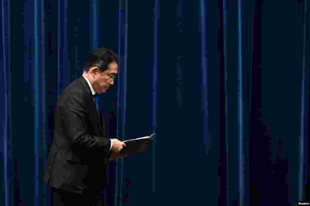 Japan's Prime Minister Fumio Kishida leaves at the end of a press conference at the prime minister's office in Tokyo, after confirming that he will not seek reelection as head of his party next month.