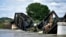 Several train cars are immersed in the Yellowstone River after a bridge collapse near Columbus, Mont., June 24, 2023. 