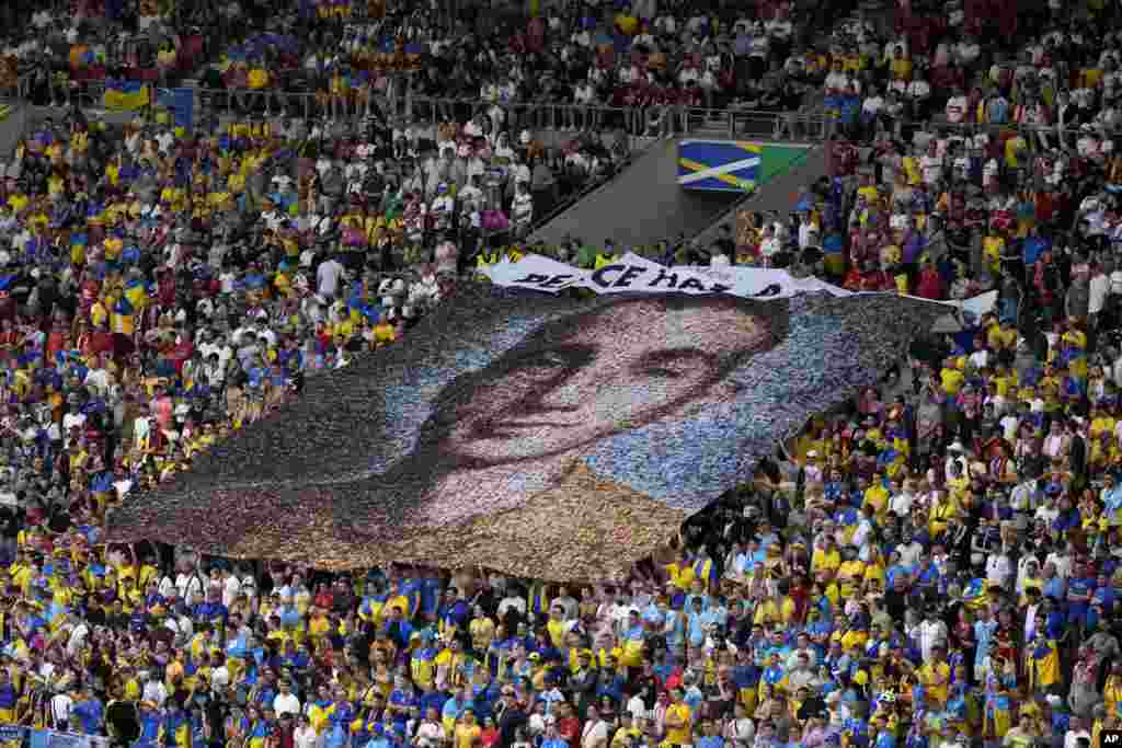 Ukraine fans display a banner reading &#39;Peace has a price&#39; and a portrait of Nazariy Hryntsevich, a fallen soldier and a football fan, during a Group E match between Ukraine and Belgium at the Euro 2024 soccer tournament in Stuttgart, Germany.