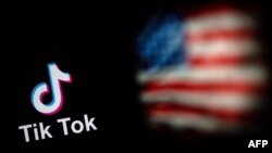 FILE: This photo collage taken on September 14, 2020 shows the logo of TikTok (L) and a US flag (R) shown on the screens of two laptops in Beijing. - The White House on Monday, February 28, 2023, gave federal agencies 30 days to purge TikTok from all government-issued devices