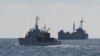 FILE - A Philippine coast guard vessel patrols near the grounded navy ship BRP Sierra Madre, April 23, 2023, where Philippine marines are stationed to assert Manila's claims at Second Thomas Shoal in the disputed South China Sea.