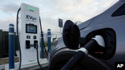 FILE - An electric vehicle charges at an EVgo fast charging station in Detroit on Nov. 16, 2022. (AP Photo/Paul Sancya, File)