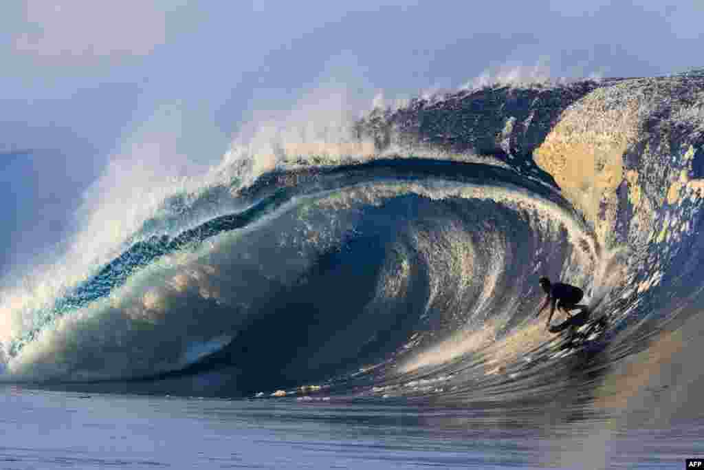 USA's surfer Kai Lenny rides a wave as a big swell hits Teahupoo, on the French Polynesia island of Tahiti, April 30, 2023.