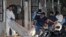 Forensic personnel remove the body of one of the eleven people killed in a pool hall in Choloma, about 180 km north of Tegucigalpa, early on June 25, 2023. 
