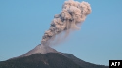 This handout photo taken and released by the Geological Agency of Indonesia on June 2, 2024 shows a volcanic eruption from Mount Lewotobi Laki-laki in East Flores, East Nusa Tenggara. (Photo by Handout / Geological Agency of Indonesia / AFP) 