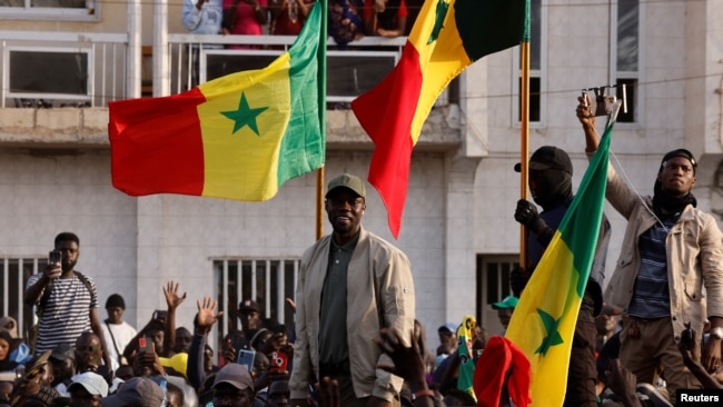 Senegalese opposition leader Ousmane Sonko greets his supporters as he arrives to attend a protest in Dakar, Senegal, March 14, 2023.
