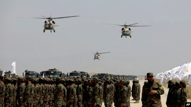 UH-60 Black Hawk helicopters fly during a military parade to mark the third anniversary of the withdrawal of US-led troops from Afghanistan, in Bagram Air Base in the Parwan Province of Afghanistan, Aug. 14, 2024.