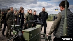 Ukraine's President Volodymyr Zelenskyy inspects newest samples of military equipment and weapons, amid Russia's attack on Ukraine, in Kyiv region, April 13, 2024. (Ukrainian Presidential Press Service/Handout via Reuters)