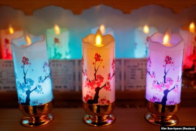 Surrounded by candles, Lee Kyoung-hyun, a YouTuber shaman, prays for people in Seoul, South Korea, May 13, 2024. (REUTERS/Kim Soo-hyeon)