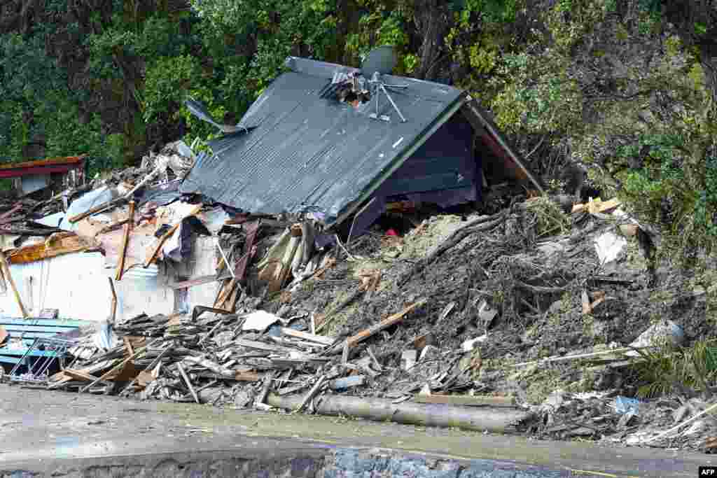 The remains of a house damaged by a storm in New Zealand&#39;s West Auckland area.