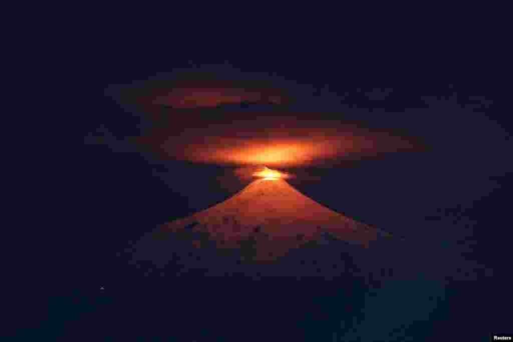 The Villarrica volcano is seen at night from Villarrica town, Chile, Dec. 20, 2023. 