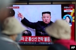 FILE - A TV screen is seen reporting on North Korea's missile launch with a file image of North Korean leader Kim Jong Un during a news program at the Seoul Railway Station in Seoul, South Korea, April 13, 2023.