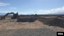 Land-moving equipment sits on the proposed site for Asman city near the village of Chyrpykhty in the Issyk Kul province of Kyrgyzstan, June 9, 2024.