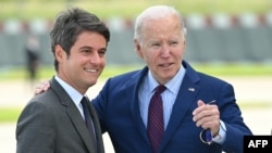 US President Joe Biden is welcomed by France's Prime Minister Gabriel Attal upon arrival at Paris Orly airport near Paris, on June 5, 2024, as he travels to commemorate the 80th anniversary of D-Day.