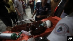 A young Palestinian wounded in the Israeli bombardment of the Gaza Strip is brought to the Kuwaiti Hospital in Rafah refugee camp, southern Gaza Strip, April 20, 2024.