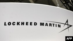 FILE - The Lockheed Martin logo is seen during the annual International Astronautical Congress at the Walter E. Washington Convention Center in Washington, Oct. 22, 2019. 