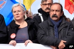 Marie Buisson, a top executive of the hard-left CGT union, and CGT union Secretary General Philippe Martinez attend a demonstration against the government's plan to raise the retirement age to 64, in Paris, March 15, 2023.