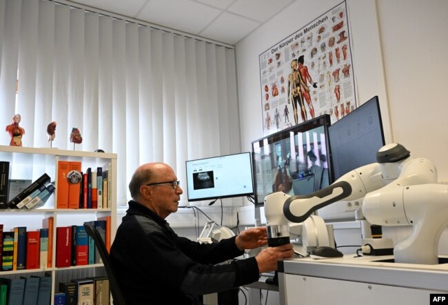 Doctor Guenter Steinebach works at a doctor's workplace for remote diagnosis in the laboratory of the Research Center Geriatronics of the Technical University Munich, in Garmisch-Partenkirchen, southern Germany, on March 6, 2023.