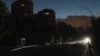 A car goes down a dark street during a partial electricity blackout in Kyiv, Ukraine, on June 5, 2024, following Russian strikes on Ukrainian energy infrastructure.