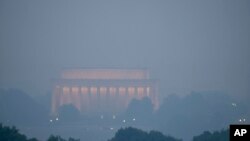 Haze blankets the Lincoln Memorial on the National Mall in Washington, June 8, 2023, as seen from Arlington, Va.