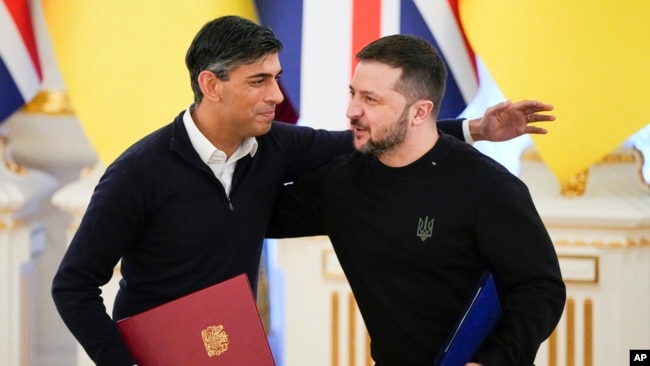 Britain's Prime Minister Rishi Sunak, left, hugs Ukrainian President Volodymyr Zelenskyy after signing documents in Kyiv, Ukraine, Jan. 12, 2024.