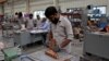 FILE - Employees assemble electric transformers inside a manufacturing unit of Inductotherm-India Private Limited at a production facility on the outskirts of Ahmedabad, India, March 28, 2024.
