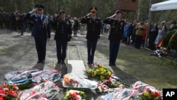 British soldiers pay tribute to Allied prisoners of war who tunneled out of a German POW camp during World War II on the 80th anniversary of the escape, in Zagan, Poland, March 24, 2024.