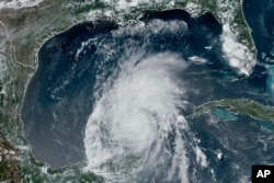 This GOES-16 GeoColor satellite image taken on July 5, 2024, and provided by NOAA, shows Hurricane Beryl over Mexico’s Yucatan Peninsula. Beryl is the first Category 5 hurricane on record in the Atlantic Ocean in June. (NOAA via AP)