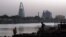 FILE — Sudanese men stand opposite the Greater Nile Petroleum Operating Company building overlooking the Nile in Khartoum, April 18, 2010.