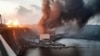 Asap dan api membubung di atas pembangkit listrik tenaga air Dnipro setelah serangan Rusia di Dnipro, Ukraina, 22 Maret 2024. (Foto: via AP)