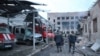 Ukrainian rescuers walk past damaged emergency service trucks next to a damaged fire station after a strike in the eastern Ukrainian city of Dnipro, amid the Russian invasion of Ukraine, in this handout photo published May 22, 2023. (AFP/State Emergency Service of Ukraine )
