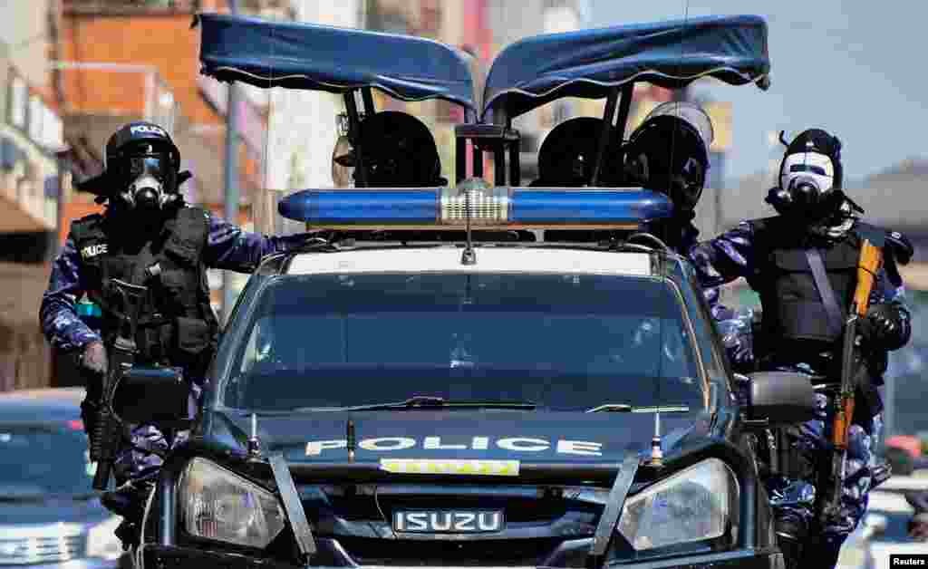 Riot police officers patrol the streets during a rally against what the protesters say are rampant corruption and human rights abuses by the country&#39;s rulers in Kampala, Uganda.