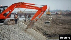 FILE - Construction of new port at the Kaladan River in Sittwe, Myanmar, May 19, 2012.