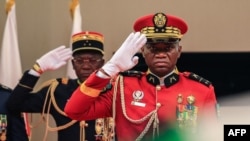 Gabon's new strongman General Brice Oligui Nguema (R) salutes as he is inaugurated as Gabon's interim President, in Libreville on September 4, 2023.