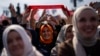 Justice and Development Party (AKP) supporters listen to party leader Recep Tayyip Erdogan, Turkey's president, during a campaign rally ahead of nationwide municipality elections, in Istanbul, March 24, 2024.