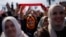 Justice and Development Party (AKP) supporters listen to party leader Recep Tayyip Erdogan, Turkey's president, during a campaign rally ahead of nationwide municipality elections, in Istanbul, March 24, 2024.