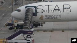The Boeing 777-300ER aircraft of Singapore Airlines is parked at Suvarnabhumi International Airport, near Bangkok, Thailand, May 22, 2024. The plane dropped around 1,800 meters in about three minutes after hitting severe turbulence over the Indian Ocean. (AP Photo/Sakchai Lalit)