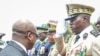 FILE - Head of Gabon's elite Republican Guard, General Brice Oligui Nguema, right, is decorated by Gabon Prime Minister Alain Claude Bilie Bie Nze in Libreville on Aug. 16, 2023, ahead of Gabon Independence Day, celebrated Aug. 17, 2023.