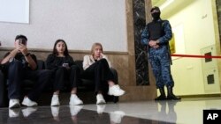 A Russian Federal Bailiffs Service employee guards a corridor leading to a courtroom as journalists wait inside a court in Yekaterinburg, Russia, July 18, 2024, during a hearing in the case of Wall Street Journal reporter Evan Gershkovich.