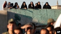 FILE - Iranians watch the hanging of convicted a man, unseen, in Qazvin, about 130 kilometers northwest of the capital Tehran, Iran, May, 26, 2011. A similar execution took place Aug. 26, 2024, in Shahroud, in northern Iran. (Mehr News Agency via AP)