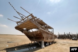 A traditional wooden ship, called a lenj, is laid ashore for restoration, in Iran's touristic Qeshm island in the Gulf, on April 29, 2023.