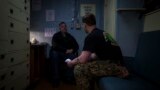 Navy Chaplain Lt. Cmdr. Ben Garrett counsels a sailor in his quarters on the USS Bataan at Norfolk Naval Station in Norfolk, Virginia, March 20, 2023.