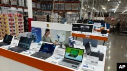 FILE - Laptop computers are displayed in a Costco warehouse, June 6, 2023, in Colorado Springs, Colorado.