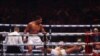 British boxer Anthony Joshua (L) competes with Cameroonian-French boxer Francis Ngannou during their heavyweight boxing match in Riyadh's Kingdom Arena indoor stadium, on March 9, 2024. 