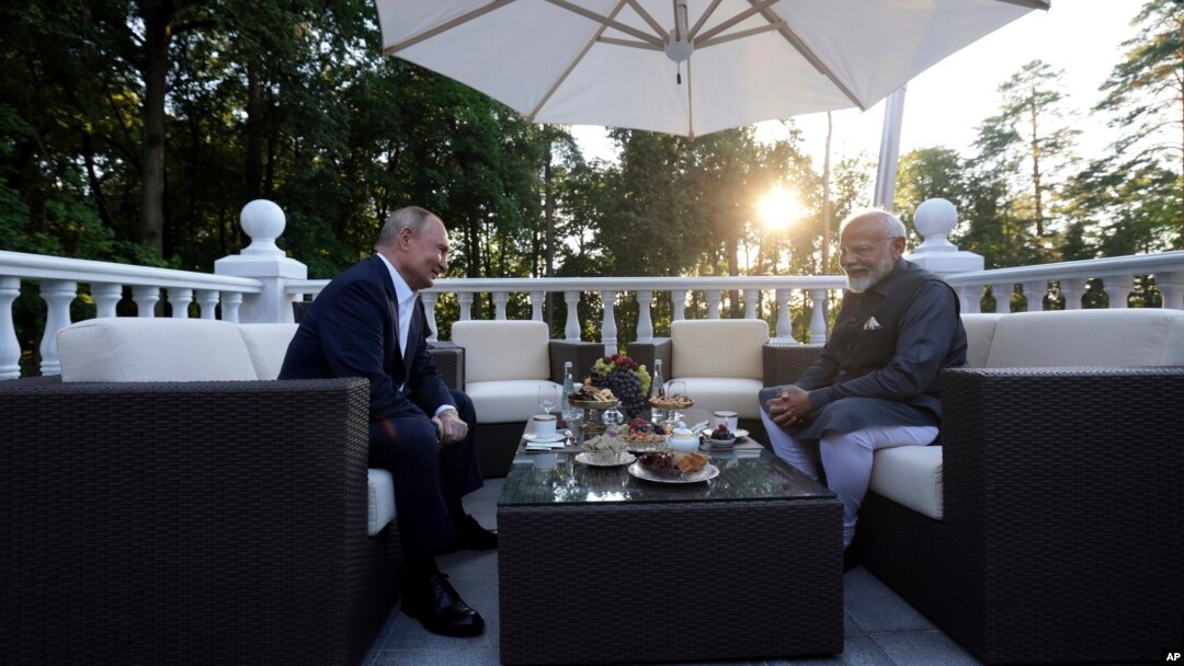 Russian President Vladimir Putin, left, speaks with Indian Prime Minister Narendra Modi during an informal meeting at Novo-Ogaryovo residence, outside Moscow, July 8, 2024.
