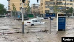 Cars are partially submerged on a flooded street, at the Mentougou district, in Beijing, China July 31, 2023, in this still image obtained from social media video. (Video obtained by Reuters)
