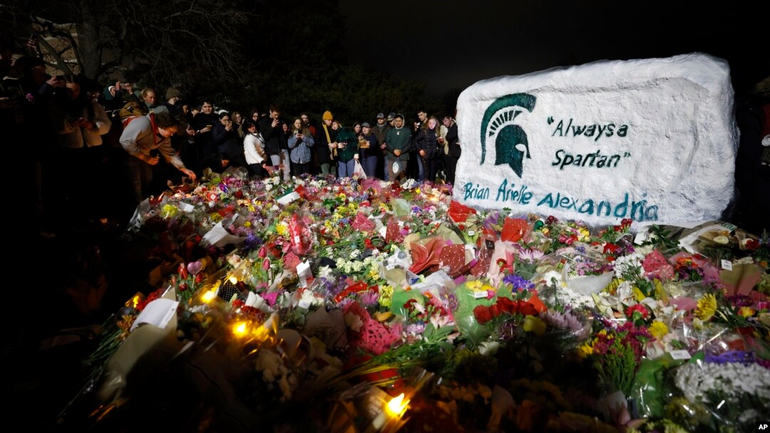Mourners attend a vigil at The Rock on the grounds of Michigan State University in East Lansing, Mich., Feb. 15, 2023. Three students were killed in a shooting, five others remain hospitalized in critical condition. 