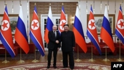 In this pool photograph distributed by the Russian state agency Sputnik, Russia's President Vladimir Putin shakes hands with North Korea's leader Kim Jong Un during a meeting in Pyongyang, June 19, 2024. (Gavriil Grigorov/Sputnik/Pool/AFP) 