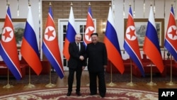 En esta fotografía distribuida por la agencia estatal rusa Sputnik, el presidente de Rusia, Vladimir Putin, estrecha la mano del líder de Corea del Norte, Kim Jong Un, durante una reunión en Pyongyang, el 19 de junio de 2024.