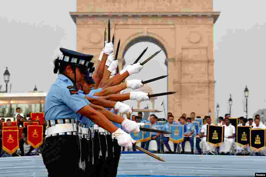 Members of Agniveervayu, the Indian Air Force's first-ever all-women drill team, perform in front of India Gate war memorial in New Delhi, India.